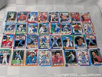 Photo showing 38 individual baseball cards arranged in 4 rows of 10, displaying various Montreal Expos players in their 1990 Topps baseball cards.