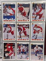 Sheet page containing nine Upperdeck hockey cards with Russian labeling, featuring various players in red and white jerseys in skating or shooting poses