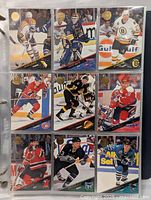 Nine hockey cards in plastic sleeve showing players in action with team uniforms from 1993-94 Leaf set.