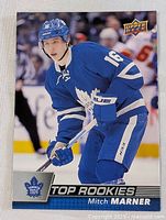 Front side of the hockey card showing Mitch Marner in full Toronto Maple Leafs gear labeled 'Top Rookies'