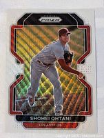 Front view of the 2022 Shohei Ohtani Prizm baseball card showing player pitching action and holographic effects with red and black border detailing.