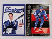 Two Auston Matthews hockey cards side by side on flat surface.