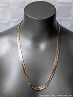 Front view of the chunky thick gold plated necklace on black mannequin bust showing length and chain style.