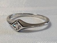 Sterling silver ring showing front diamond setting on the band.