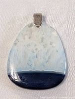 Front view of triangular stone pendant with blue and white marbling and navy blue base with sterling silver clasp.