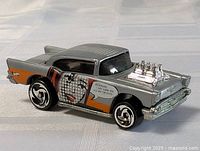 Front side view of the diecast car showing the stylized face graphic and chrome engine details.