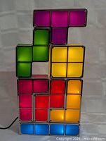 Photo showing the vintage Tetris lamps illuminated and stacked in a decorative arrangement demonstrating the light emission and colors.