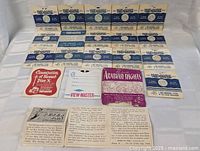 Front view showing 14 View-Master reels in white and blue sleeves titled '7 More Wonders of the World' with additional reels and booklets laid out below.