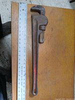 Full view of the 24 inch Ridgid pipe wrench next to a ruler for scale