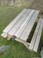 Angled side view capturing table length with tape measure.