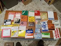 Overview of all items on table showing Pepsi cards, various shipping labels, and war buttons
