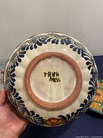 Bottom of ceramic piece showing marking 'TRUTH MEX' and blue floral pattern on white ceramic base.