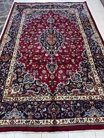 Full view of the rug laid flat on tiled floor.