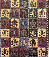 Top detail showing the color panels with abstract floral and geometric motifs in red, blue, yellow and cream.