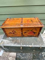 Front and top view of painted wood toy chest showing size and graphics