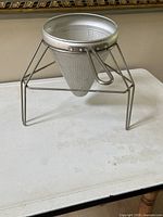strainer resting in stand, full view
