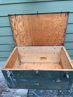 Chest open showing interior wood and hinged lid