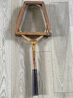 Full view of racket inside wooden press