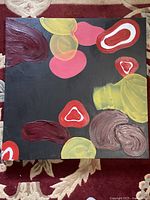 Full view of square abstract painting on canvas stretcher