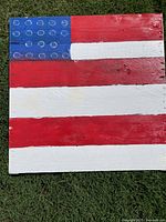 Full view of wooden American flag showing stripes and canton