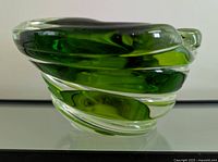 Side view showing the thickness and twisted clear and green glass design