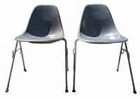 Two chairs front view on pavement