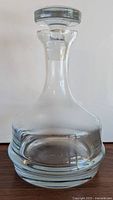 Full view of the clear glass Krosno decanter showing its wide base and curved body.