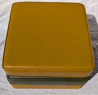Stacked view showing top cushion mustard yellow vinyl, two others below mustard yellow and olive green respectively