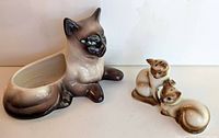 Reclining Siamese cat planter beside Siamese cat salt and pepper shakers.