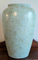 Front view of the vintage West Germany pottery vase showing the textured speckled light blue and beige glaze.