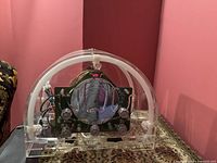 Front view of the transparent radio showing the circuitry and tuning dial inside the clear acrylic case.