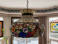 Full view of the kitchen lamp showing stained glass shade with floral and geometric patterns.