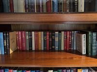 Bookshelves with a diverse range of hardcover books in English and German.
