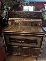 Front view showing illuminated top graphic, selector keys and “Americana III” logo