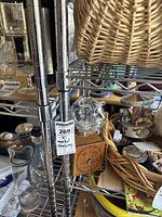 Close-up image showing a 4-foot tall chrome metal wire shelving unit with a MaxSold price tag.