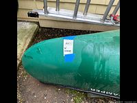 Bow and starboard side showing blue auction sticker and “Camper” decal