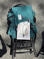 Top view of EMS hiking backpack with original packaged Osprey hydration bladder on top.