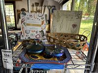 Overview of glass candies, oil lamps on ceramic pumpkin plate, sunflower glass plate, woven basket, and recipe binders