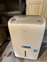 Front view of white Home 50 pint dehumidifier with water level indicator window and Home logo