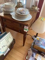 End table with drawer, light wood, visible single drawer with two metal pulls, tapered legs with carved accents. Dimensions sticker attached at corner: 20x27x22 inches.