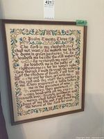 Full frontal image of the framed petit point embroidery detailing Psalm Twenty Three with floral border in a wooden frame.