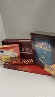Lot including Sorry! vintage unopened board game, Scrabble, Pictionary board games, and PC Gamepad for Windows 95/98.