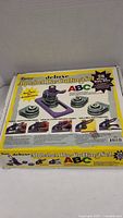 Boxed Darice deluxe alphabet die cutting set showing heavy-duty machine and dies with letter A example