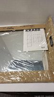 Original packaging of the IKEA Krabb mirrors showing box and part of instruction manual.