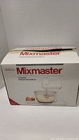 Box of Sunbeam Mixmaster 5-speed stand and hand mixer showing front with unit image and branding.
