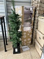 Small decorative artificial potted tree, black square base, some wear marks, standing about 49 inches tall.