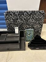 Photo showing all four items: black velvet memo board, black wood desk organizer, black plastic corner caddy, and 2025 planner notebook.