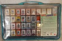 Top view of the Cutting Edge paper punch set with all punches visible inside clear plastic lid case