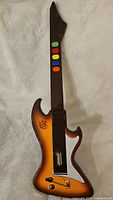 Full view of the React wireless guitar for PlayStation 2 showing colored fret buttons and full body design.