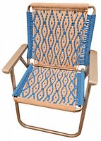 Front angled view of vintage lawn chair showing the hand-knitted blue and tan woven seat and backrest with tubular aluminum frame and armrests.